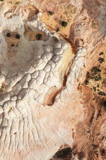 Aerial view capturing a desert landscape with rock formations, showcasing natural textures and