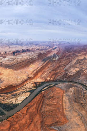 Captivating aerial view of a sprawling San Juan canyon with layered rock formations and a