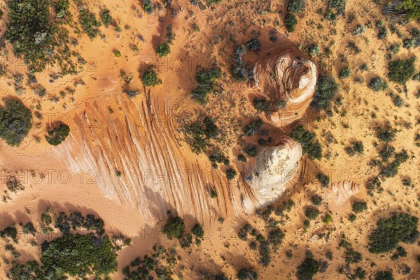Aerial shot showcases a desert landscape with unique rock formations and contrasting vegetation in