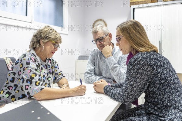 A couple with intellectual disabilities engaged in a focused supervision meeting. They are