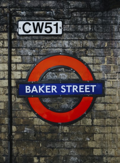 A vibrant image of the Baker Street station sign on London's Underground, set against a textured