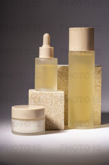 A stylish arrangement of cosmetic bottles in different sizes, showcased on textured stone podiums,