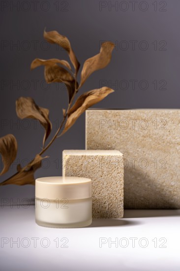 A stylish presentation of a cosmetic cream jar, set against a background of natural stone podiums