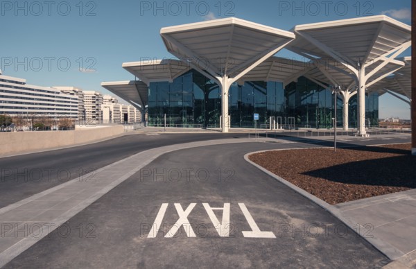 A spacious and modern transport hub in Valdebebas, Madrid, featuring a metro station, underground