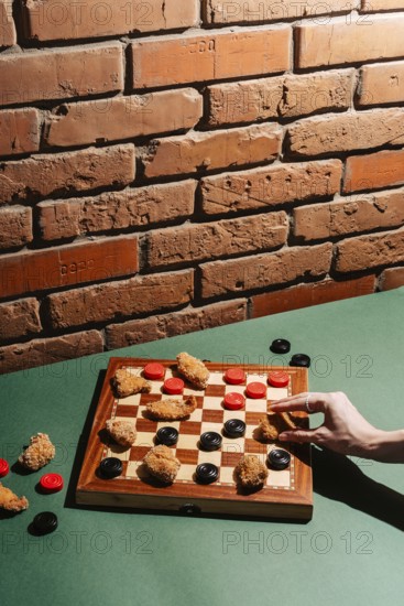 A creative take on checkers using chicken nuggets as game pieces on a board, set against a rustic