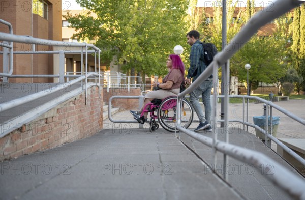 A couple navigating their college campus, with the woman using a wheelchair due to spina bifida