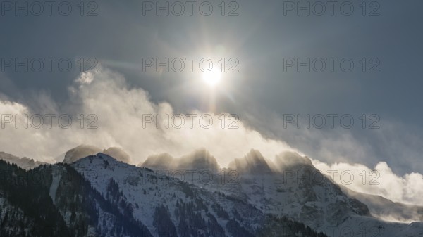 Dramatic winter morning with bright sun shining over the snow covered Les Dents du Midi peaks in