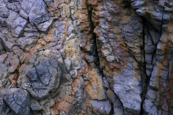 Detailed view of the textured rock formations at Mujeres Beach in Lanzarote, showcasing a variety