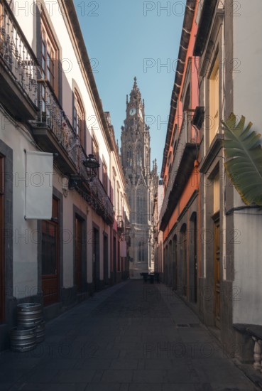 A serene cobblestone street leading to the iconic San Juan Bautista Church in Arucas, Gran Canaria,