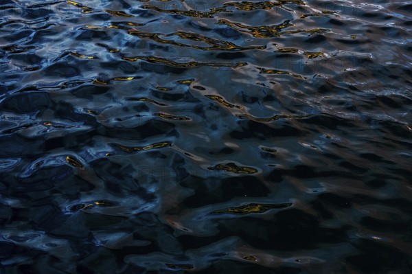 Dark and moody water textures captured at Playa Blanca Port in Lanzarote. Intricate light