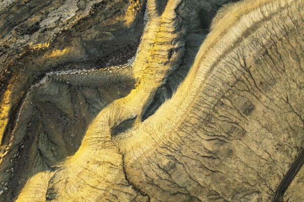 A stunning aerial capture of the golden sandstone formations in Utah, USA. The intricate patterns