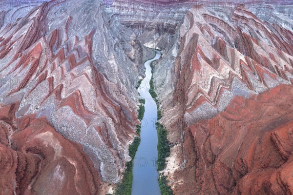 A captivating aerial shot of the winding Rio San Juan flowing through the vibrant red rock