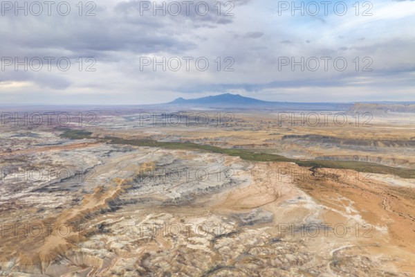 A stunning aerial drone view capturing the vast, rugged landscape of Hanksville, Utah, highlighting