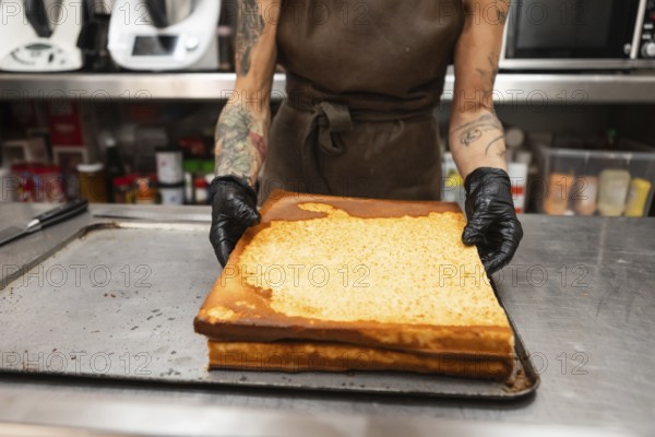 A baker in an Italian bakery handles freshly baked pastries The kitchen environment reflects