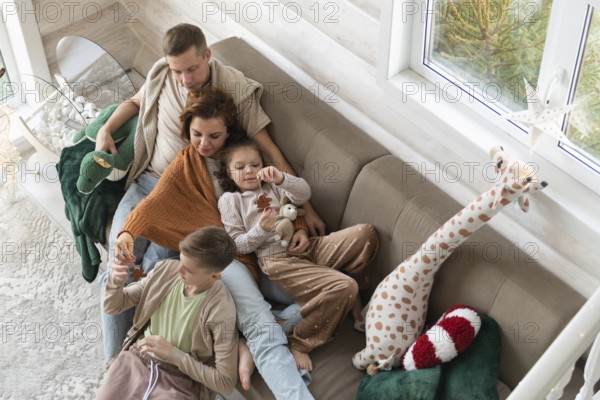 Top view of a festive setting with a winter view and holiday deco. A joyful family celebrates