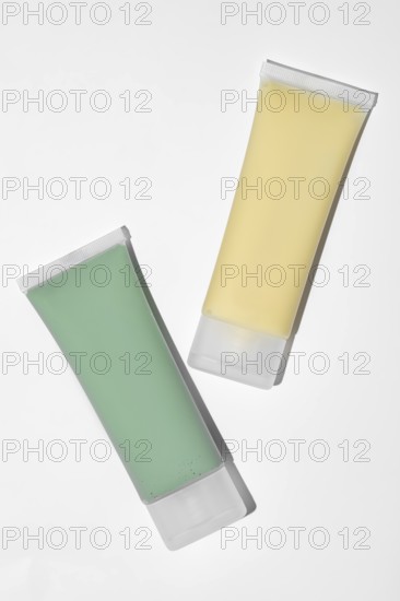 Two skincare face mask tubes, on white background. The green tube contains a spirulina, kaolin, and