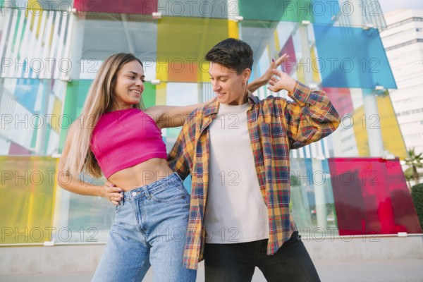 A joyful lesbian couple shares a playful dance, smiling and enjoying the moment. The vibrant glass