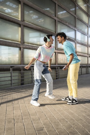 A happy couple shares a joyful moment outdoors, dressed in colorful, casual outfits. Smiling and