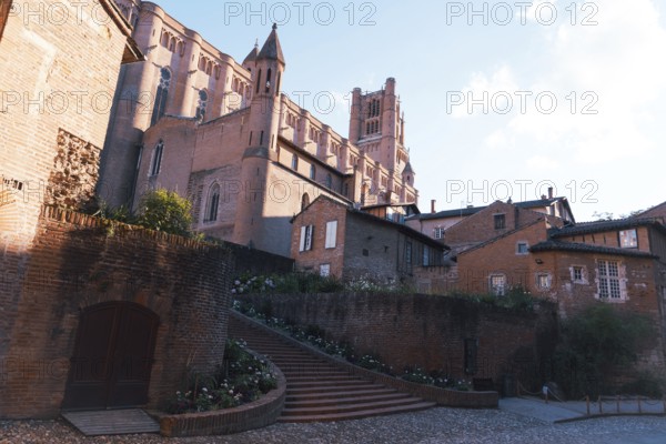 A striking view of a medieval Berbie Palace under a bright, clear sky in Albi, France The image