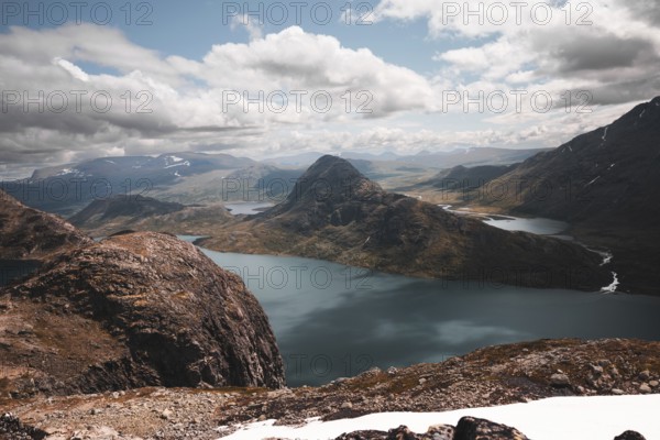 A stunning panoramic view of rugged mountain peaks and pristine lakes in Norway The dramatic