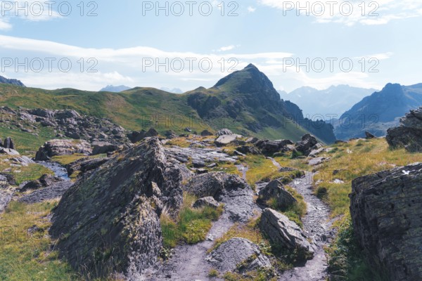 A scenic hiking trail winds through rocky terrain at the Ibones de Anayet in Huesca, Spain,