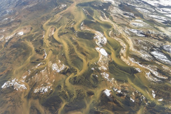 Aerial view of Iceland's rivers showcasing intricate textures and vibrant colors. The landscape