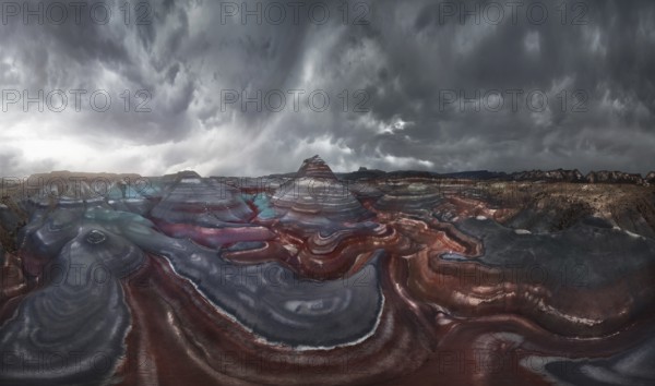 A mesmerizing landscape of colorful, striped geological formations under a dramatic, cloudy sky.