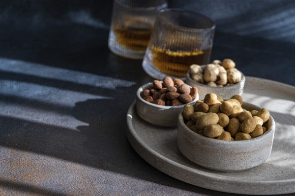 Spiced cognac cocktail accompanied by cinnamon and anise star spice, served with a variety of nuts,