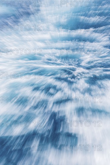 Blurred water effect creating a sense of speed and movement. The light reflections add a vibrant