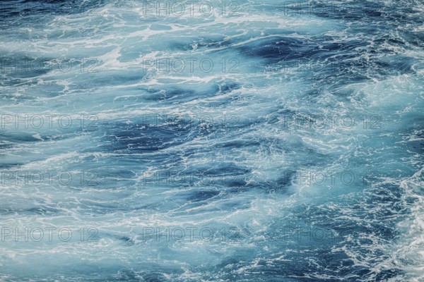 Calm water surface with soft ripples and shades of blue. A peaceful and serene moment of nature