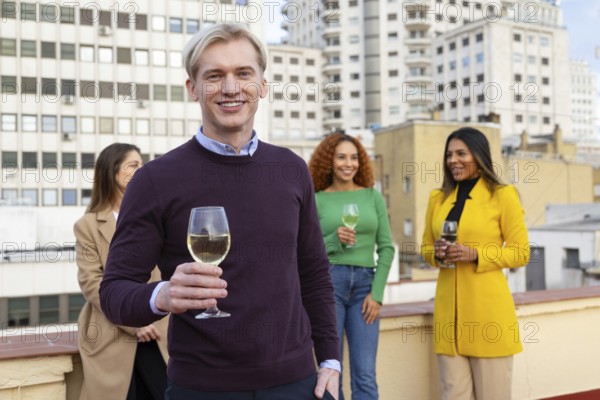 A group of friends gathers on a rooftop, enjoying a joyous celebration with drinks in hand, set