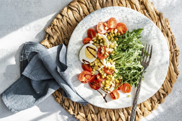 Delicious and nutritious keto salad featuring boiled eggs, fresh rocket, cherry tomatoes, canned