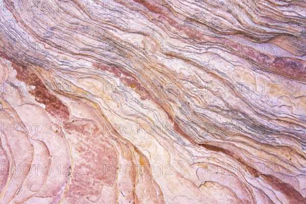 Close-up image showcasing the intricate patterns and warm hues of red rock formations that reveal