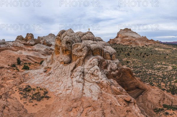 Unrecognizable person standing on a unique rock formation at White Pocket, Arizona, USA,