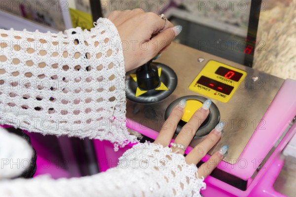 Gen Z girl enjoys her time at an arcade, using joystick controls for entertainment The vibrant
