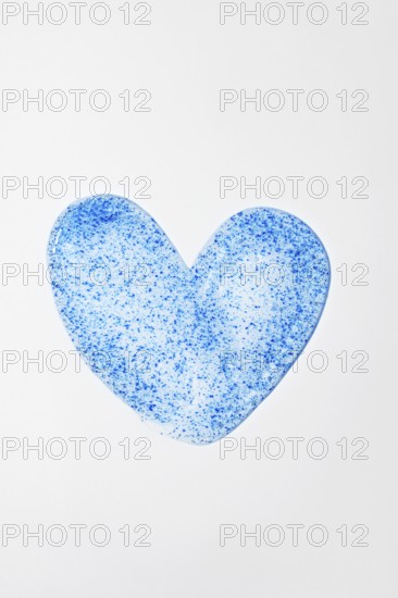 A close-up of face scrub in a heart shape, featuring blue micro-exfoliating particles Ideal for