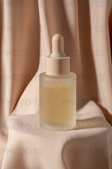 A minimalist frosted glass bottle with a dropper, containing skincare serum, is placed against