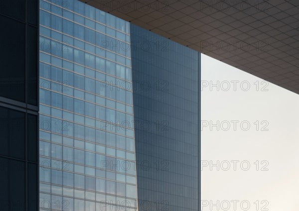 Close-up view of sleek, modern glass buildings in a downtown setting showcasing contemporary