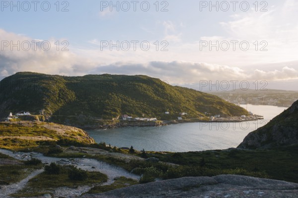 A serene view of Signal Hill, St. John's showcasing a sweeping coastline with a sunlit harbor