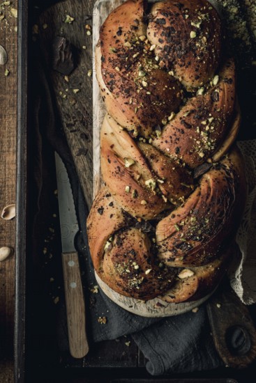 Top view of an artisanal chocolate and pistachio bakbah bread, beautifully presented on a dark
