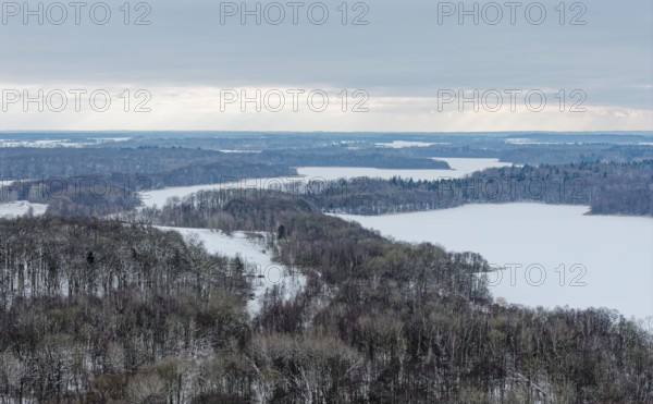 There is snow on the fields and lakes in the UNESCO Schaalsee Biosphere Reserve. aerial view.