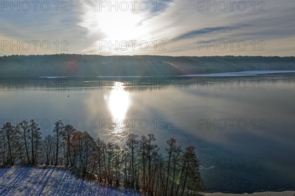 The sun reflects on Lake Werbellin in the UNESCO Schorfheide-Chorin Biosphere Reserve in winter.