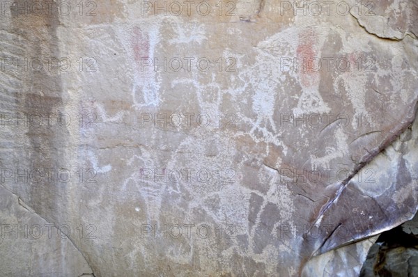 Abstracted figures and symbols as petroglyphs from the Fremont culture on a stone surface, Dinosaur