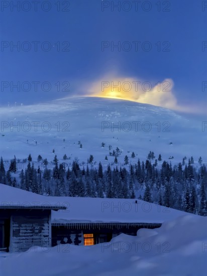 Snow sweeps over the fells in front of the moon at twilight, Hotel Pallas, Pallas-Yllästunturi