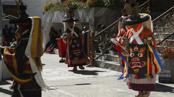People in traditional costumes dance outside at a cultural event in Leh, trekking in Ladakh,