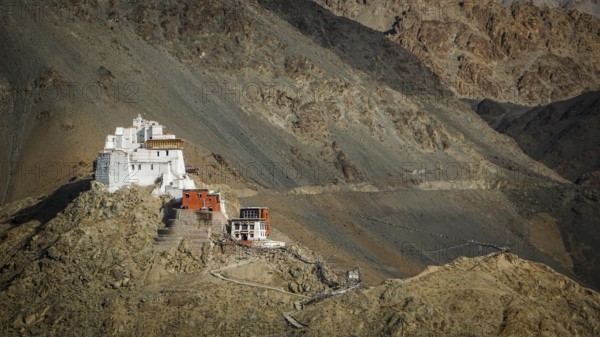 Namgyal Tsemo Buddhist monastery nestled in the barren mountains on a escarpment, Leh, trekking in