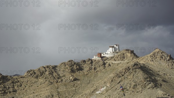 Namgyal Tsemo Buddhist monastery in Leh perched on a rocky hill under impending clouds, mountain