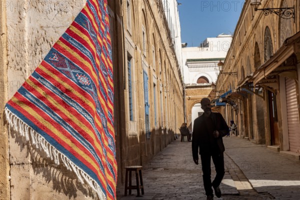 Tunis, Tunisia 4th May, 2024 A beautiful traditional woven rug hangs outside a shop in the souk of