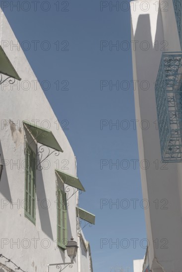 Mediterranean style architecture of shuttered windows and white washed walls in the Medina of