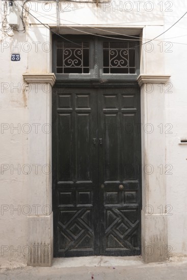 Green door of the childhood home of Ibn Khaldun, Arab Muslim sociologist and philosopher born in